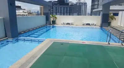 a swimming pool on the roof of a building at Rsquared Condo in Manila