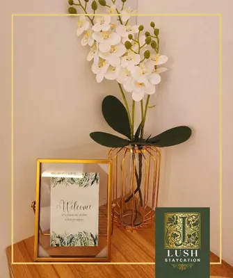 a vase filled with white flowers sitting next to a box at Modern Condo Near Ayala Avenue Makati City CBD at Lush Residences in Manila