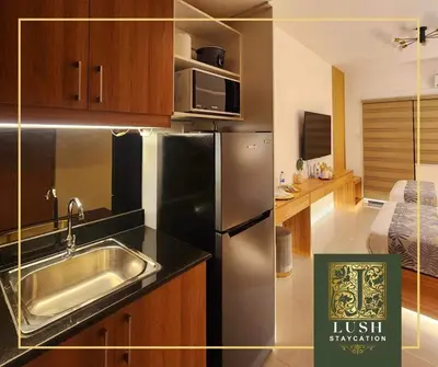 a kitchen with a stainless steel refrigerator and a sink at Modern Condo Near Ayala Avenue Makati City CBD at Lush Residences in Manila