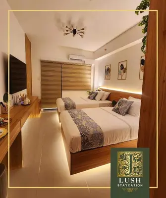 a bedroom with two beds and a ceiling fan at Modern Condo Near Ayala Avenue Makati City CBD at Lush Residences in Manila