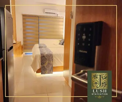 a view of a room with a bed and a mirror at Modern Condo Near Ayala Avenue Makati City CBD at Lush Residences in Manila