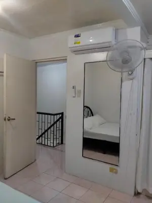 a bedroom with a mirror and a bed in a room at San Isidro Cabuyao TRANSIENT in Banlik