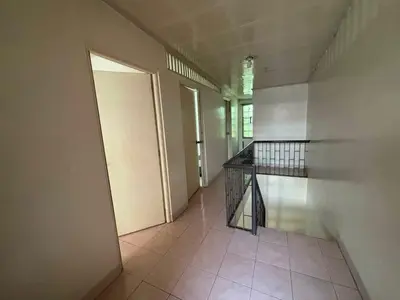 an empty hallway with a door in a building at San Isidro Cabuyao TRANSIENT in Banlik