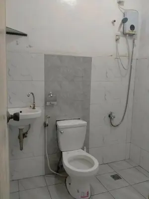a bathroom with a toilet and a sink at San Isidro Cabuyao TRANSIENT in Banlik