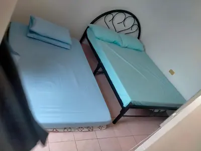 two beds sitting next to each other in a room at San Isidro Cabuyao TRANSIENT in Banlik