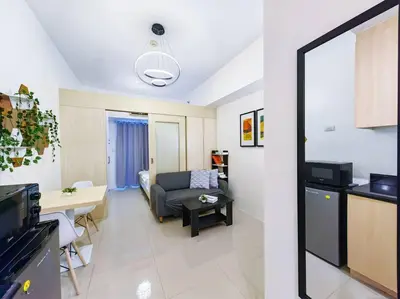a living room with a couch and a table at 1BR Condotel with Balcony at SM Light Residences #LT06 in Manila