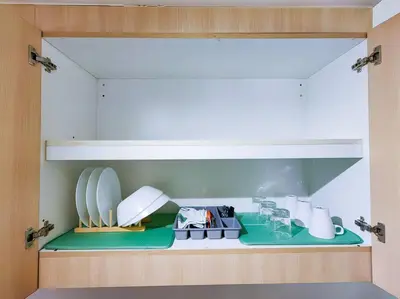 a kitchen with a shelf with plates on it at 1BR Condotel with Balcony at SM Light Residences #LT06 in Manila