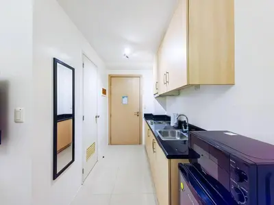 a kitchen with a sink and a counter top at 1BR Condotel with Balcony at SM Light Residences #LT06 in Manila