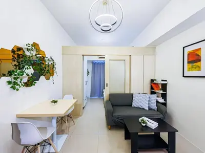 a living room with a couch and a table at 1BR Condotel with Balcony at SM Light Residences #LT06 in Manila