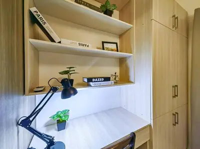 a room with a desk with a lamp and shelves at 1BR Condotel with Balcony at FAME Residences #FM09 in Manila