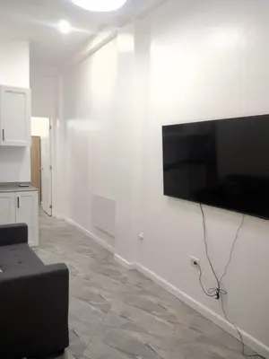 a living room with a flat screen tv on a wall at Bellas Apartment u1 in Manila