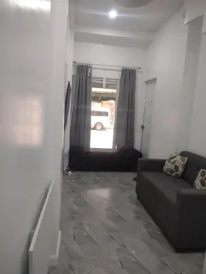 a living room with a couch and a window at Bellas Apartment u1 in Manila