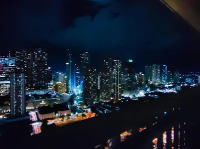 a view of a city at night with lights at 1BR Condotel with Balcony at FAME Residences #FM13 in Manila