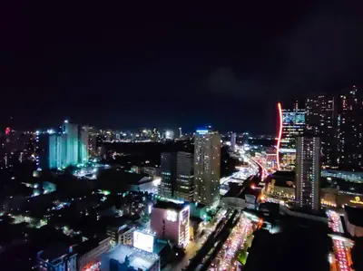 a view of a city at night with lights at 1BR Condotel with Balcony at FAME Residences #FM13 in Manila