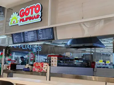 a fast food restaurant with a counter with a person at 1BR Condotel with Balcony at FAME Residences #FM13 in Manila