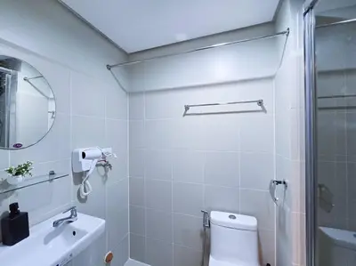 a bathroom with a shower and a toilet and a sink at 1BR Condotel with Balcony at FAME Residences #FM14 in Manila