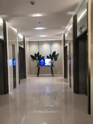 a hallway in a building with a tv on a table at SMDC Coast Residences in Manila