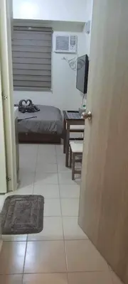 a room with a bed and a television and a door at CasaMontero@UrbanDecaTowers EDSA in Manila