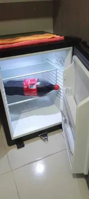 a bottle of wine sitting inside of a refrigerator at CasaMontero@UrbanDecaTowers EDSA in Manila