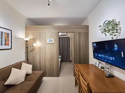 a living room with a couch and a flat screen tv at 1BR Condotel with Balcony at FAME Residences #FM22 in Manila