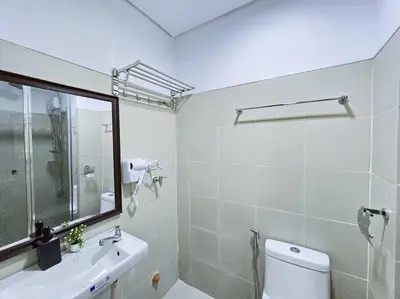 a bathroom with a toilet and a sink and a mirror at 1BR Condotel with Balcony at FAME Residences #FM23 in Manila