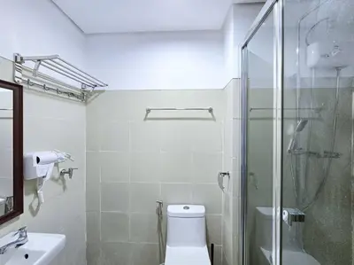 a bathroom with a shower and a toilet and a sink at 1BR Condotel with Balcony at FAME Residences #FM23 in Manila