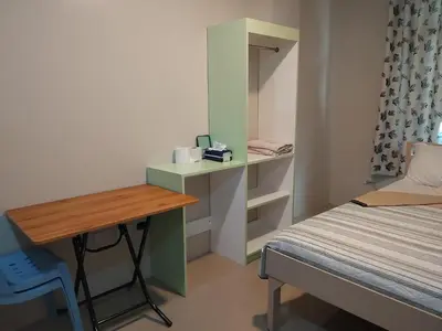 a small room with a bed and a desk at AGB Anchorage Inn in Manila