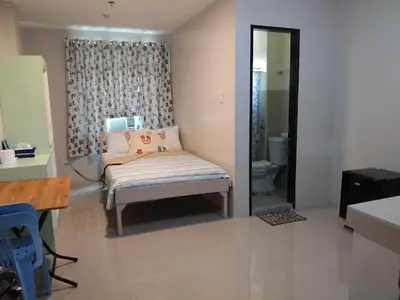 a living room with a bench and a toilet at AGB Anchorage Inn in Manila