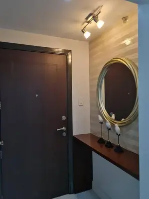 a bathroom with a brown door and a mirror at Big 2BR near Burgos Circle, Highstreet, St Lukes - B Parklane T1 in Manila