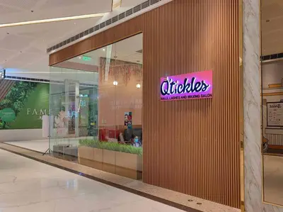a store with a sign on the side of a building at 1BR Condotel with Balcony at FAME Residences #FM08 in Manila