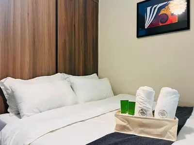 a hotel room with a bed with towels on it at 1BR Condotel with Balcony at FAME Residences #FM26 in Manila