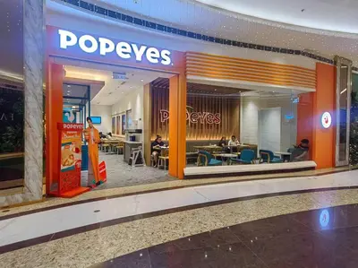 a pepsi store in a mall with people sitting in chairs at 1BR Condotel with Balcony at FAME Residences #FM26 in Manila