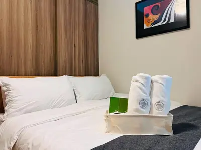 a hotel room with a bed with towels on it at 1BR Condotel with Balcony at FAME Residences #FM27 in Manila