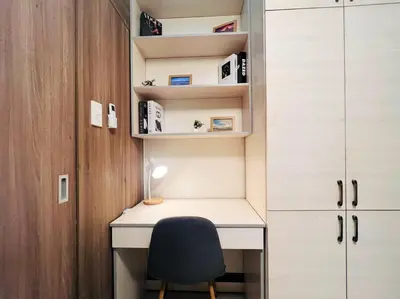 a desk with a chair next to a cabinet at 1BR Condotel with Balcony at FAME Residences #FM28 in Manila