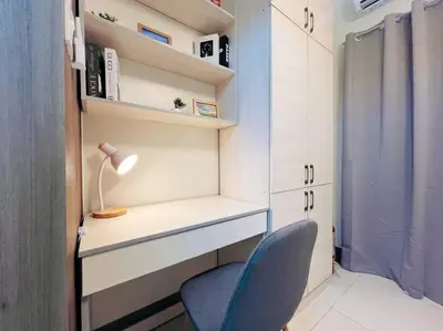 a room with a desk and a blue chair at 1BR Condotel with Balcony at FAME Residences #FM28 in Manila