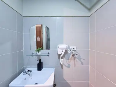 a white bathroom with a sink and a mirror at 1BR Condotel with Balcony at FAME Residences #FM29 in Manila