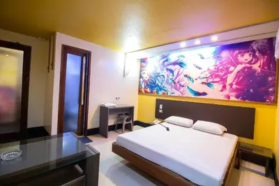 a bedroom with a bed and a painting on the wall at Hotel Dreamworld Las Pinas in Manila