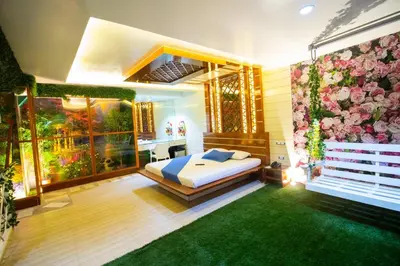 a bedroom with a bed and a wall of flowers at Hotel Dreamworld Las Pinas in Manila