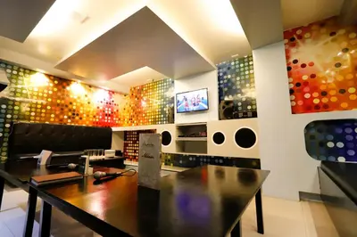 a dining room with a table and a wall of wine bottles at Eurotel Las Pinas in Manila