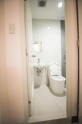 a small bathroom with a toilet and a sink at Astrotel Calamba in Calamba
