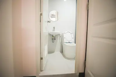 a white bathroom with a sink and a toilet at Astrotel Calamba in Calamba