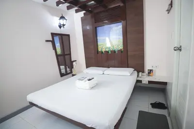 a bedroom with a large white bed in a room at Astrotel Calamba in Calamba