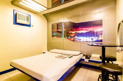 a hospital room with a bed and a table at Astrotel Guadalupe in Manila