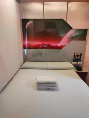 a bed with two towels on it in a room at Astrotel Guadalupe in Manila