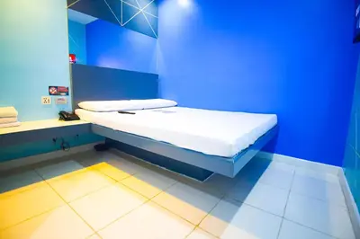 a blue room with a bed in a blue room at Astrotel Divisoria in Manila