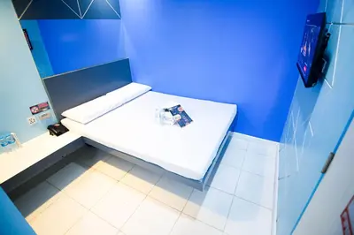 a blue room with a white bench in a bathroom at Astrotel Divisoria in Manila