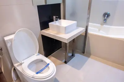 a bathroom with a toilet and a sink at Hotel Dreamworld Araneta Cubao in Manila