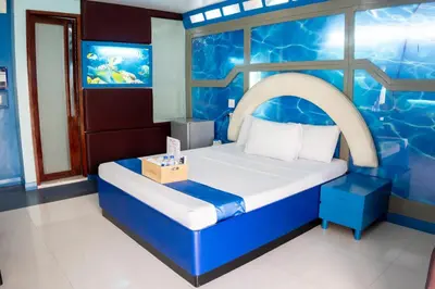 a room with a bed in a water themed room at Hotel Dreamworld Araneta Cubao in Manila