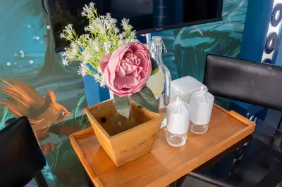 a vase with a pink flower on a table at Hotel Dreamworld Araneta Cubao in Manila