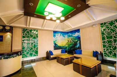 a lobby with couches and a painting on the wall at Hotel Dreamworld Araneta Cubao in Manila